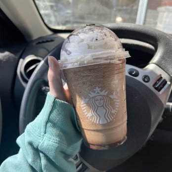 Starbucks - a hand holding a cup of iced coffee - Coffee & Tea Near Me - St. Louis, Missouri Starbucks - a hand holding a cup of iced coffee - Coffee & Tea Near Me - St. Louis, Missouri