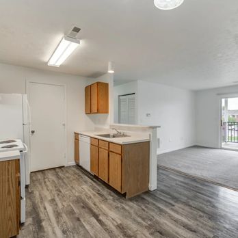 Crystal Glen - An empty kitchen and living room with a door to a balcony - Apartments Near Me - Findlay, Ohio Crystal Glen - An empty kitchen and living room with a door to a balcony - Apartments Near Me - Findlay, Ohio