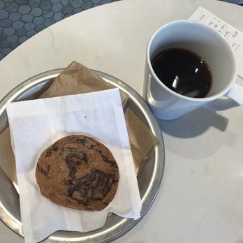 Flour Bakery + Cafe - Tcho chocolate chip cookie with a large coffee - Coffee & Tea Near Me - Cambridge, Massachusetts