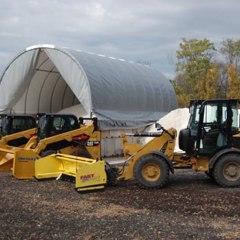 ABC Landscaping - a loader and a bulldozer parked in front of a tent - Snow Removal Near Me - Kent, Ohio