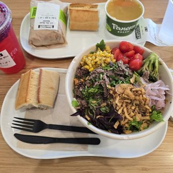 Panera Bread - Ultimate Garden Steak Salad in foreground paired with a plain baguette. - Salad Near Me - Schertz, Texas
