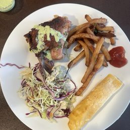Chicken Thigh, slaw, fries, corn tortilla, and sauces