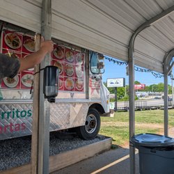 Taqueria el Cazador - Under awning by taco truck.