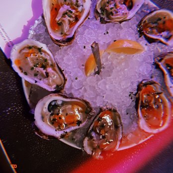 Devil May Care - EAST COAST OYSTERS* 4/ea Aqua Pazza, Chili Oil, Chives - Lounges Near Me - Austin, Texas