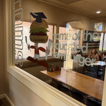 Tom's - a woman sitting at a table in a restaurant - Burgers Near Me - Lompoc, California