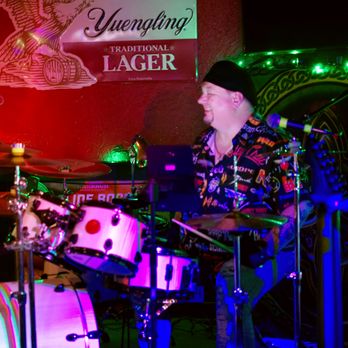 Molly Maguires - a man playing drums on stage - Bars Near Me - Houston, Texas
