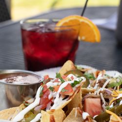 The Nest Bar & Grill - Pulled Pork Nachos. Ice Cold Drink. Yes & yes.