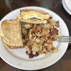 Millies Restaurant - egg and cheese with sausage sandwich and a side of home fries.