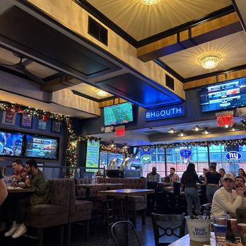 Blue Haven South - people sitting at tables and watching televisions - Sports Bars Near Me - New York, New York Blue Haven South - people sitting at tables and watching televisions - Sports Bars Near Me - New York, New York