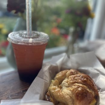 Sunrise Kava Cafe - Bruiseberry bubble tea and a bacon egg and cheese croissant - Cafes Near Me - Oscoda Township, Michigan Sunrise Kava Cafe - Bruiseberry bubble tea and a bacon egg and cheese croissant - Cafes Near Me - Oscoda Township, Michigan