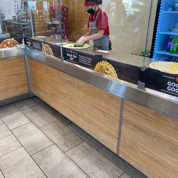 Papa Murphy's - a man preparing food in a restaurant - Pizza Near Me - Henderson, Nevada