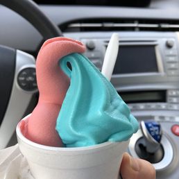 a person holding a cup of ice cream a person holding a cup of ice cream