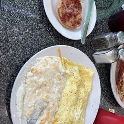 Meat omelette, grits and English muffin.