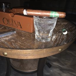 a glass of water and a cigar on a table