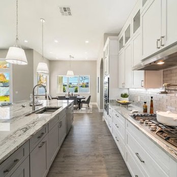Athena Development - a kitchen with white cabinets and marble countertops - Countertop Installation Near Me Athena Development - a kitchen with white cabinets and marble countertops - Countertop Installation Near Me