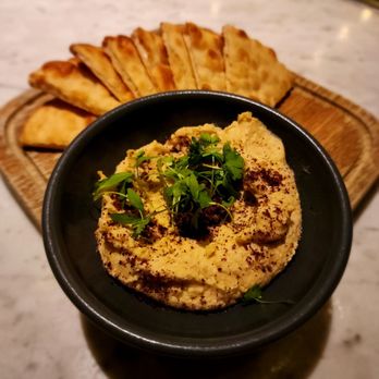 The Outsider - a bowl of hummus and pita chips - Lounges Near Me - Milwaukee, Wisconsin The Outsider - a bowl of hummus and pita chips - Lounges Near Me - Milwaukee, Wisconsin