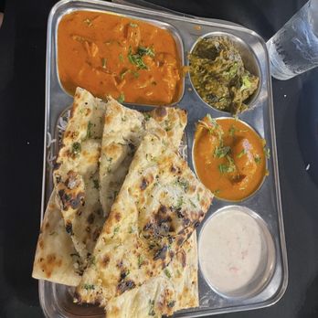 Twist India - Non-Veg Thali, that comes with three Non Veg Dishes, Garlic Naan, Rice, Raita, piece of Chicken Tandoori and Gulab Jamun as dessert. - Indian Near Me - Richmond, Indiana Twist India - Non-Veg Thali, that comes with three Non Veg Dishes, Garlic Naan, Rice, Raita, piece of Chicken Tandoori and Gulab Jamun as dessert. - Indian Near Me - Richmond, Indiana