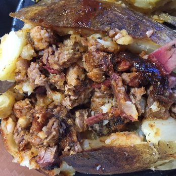Baker Boys BBQ - Close up of baked potato loaded with brisket. - Barbeque Near Me - Gonzales, Texas Baker Boys BBQ - Close up of baked potato loaded with brisket. - Barbeque Near Me - Gonzales, Texas