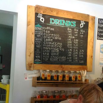 Uprooted - a woman leaning over a counter in a restaurant - Farmers Market Near Me - Musquodoboit Harbour, Nova Scotia