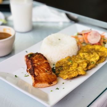 El Sazon de Doña Eva - Chefs Specialty: Grilled Salmon with fried plantains, rice, pinto beans and salad. // Salmon con tostones, arroz, frijoles y ensalada. - Latin American Near Me - Upper Darby, Pennsylvania El Sazon de Doña Eva - Chefs Specialty: Grilled Salmon with fried plantains, rice, pinto beans and salad. // Salmon con tostones, arroz, frijoles y ensalada. - Latin American Near Me - Upper Darby, Pennsylvania