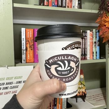 Dog Ears Cafe & Bookstore - a hand holding a cup of coffee - Bookstores Near Me - Buffalo, New York Dog Ears Cafe & Bookstore - a hand holding a cup of coffee - Bookstores Near Me - Buffalo, New York