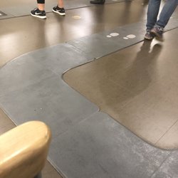 Kaiser Permanente Medical Center-Santa Rosa - Seats have no place for feet given preordained wait line shown in grey mats