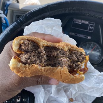 Original Gilmore Burgers - a hand holding a hamburger - Burgers Near Me - Houston, Texas Original Gilmore Burgers - a hand holding a hamburger - Burgers Near Me - Houston, Texas