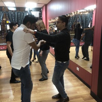 Latin Techniques Dance Studio - The instructor (on the right side) teaching a student. - Dance Studios Near Me - Chicago, Illinois