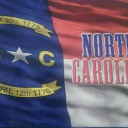 Tsunami Surf & Resort Wear - NC flag postcard