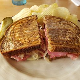Rueben sandwich with side of Parmesan garlic chips with a pickle Rueben sandwich with side of Parmesan garlic chips with a pickle