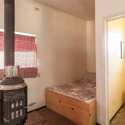 Sierra Gateway Cottages - Kern Bunkhouse has a queen bed in this downstairs area as well as two singles, upstairs area has a double bed, one and one half baths