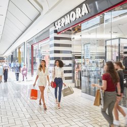Tysons Corner Center - Shoppers carrying bags walk past Sephora inside Tysons Corner Center.