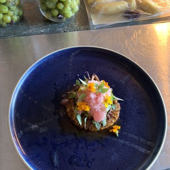 Dokke - Octopus tentacle coiled on top of Kimchi - Asian Fusion Near Me - London, XGL