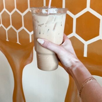 The Hive - a hand holding a cup of iced coffee - Bakeries Near Me - Willard, Missouri The Hive - a hand holding a cup of iced coffee - Bakeries Near Me - Willard, Missouri