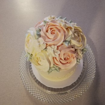 Caked - a close up of a cake on a glass plate - Desserts Near Me