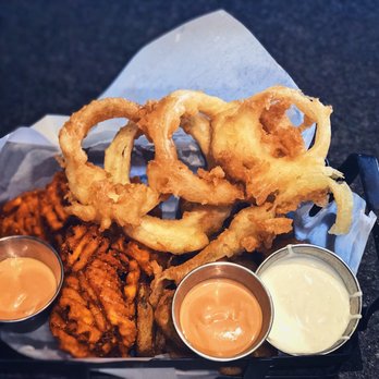 Hug Hes - 3-pick appetizer: waffle-cut, sweet potatoes fries; lightly battered onion rings; and fried pickles. - New American Near Me - Centerville, Utah Hug Hes - 3-pick appetizer: waffle-cut, sweet potatoes fries; lightly battered onion rings; and fried pickles. - New American Near Me - Centerville, Utah