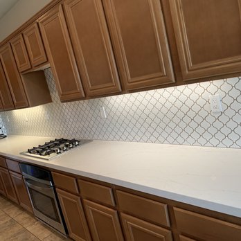 Bros Tile & Stone - a kitchen counter with a stove - Flooring Near Me Bros Tile & Stone - a kitchen counter with a stove - Flooring Near Me