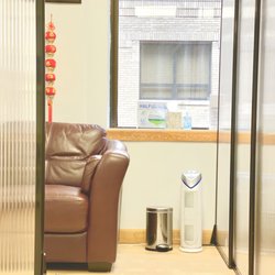Malden Dental Associates - Partitioned individual waiting area with hand-sanitizer & HEPA/UV germguardian air purifier