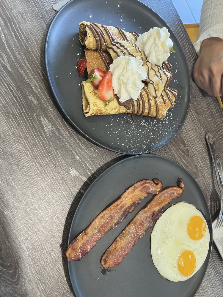 Strawberry banana Nutella crepes with a side of bacon and eggs Yelp