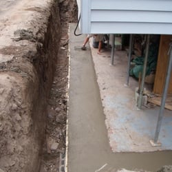 All-Pro Waterproofing & Excavating Inc - a new footing is poured and leveled to the correct height, but left a bit rough in order to help the new block grab better.