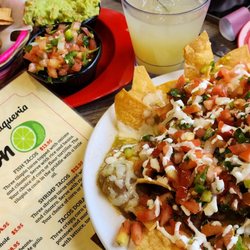 El Limon - Chips, Salsa /Guacamole chips!  Then a complimentary and extremely delicious margarita! Loaded Nachos with tinga!