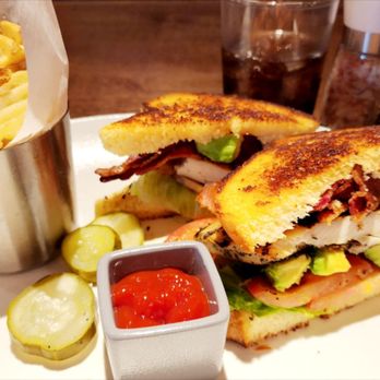 Hanna's Table - Grilled chicken sandwich with bacon, avocado, lettuce, tomato, pickles, and waffle fries. - Bars Near Me - Reno, Nevada Hanna's Table - Grilled chicken sandwich with bacon, avocado, lettuce, tomato, pickles, and waffle fries. - Bars Near Me - Reno, Nevada