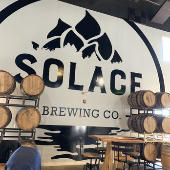 Solace Brewing Company - Main seating area showing logo. - Breweries Near Me - Sterling, Virginia