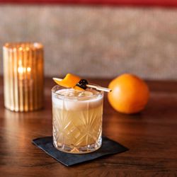 Portofino Restaurant & Bar - Golden glow, bold garnish, and a pour that sets the mood. This is cocktail hour done right.