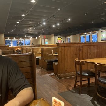 Outback Steakhouse - a man sitting at a table - Steakhouses Near Me - Jacksonville, North Carolina Outback Steakhouse - a man sitting at a table - Steakhouses Near Me - Jacksonville, North Carolina