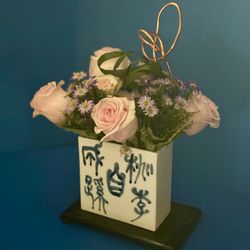 East Meets West Flowers - Japanese vase enhances the tall gold curved sculpture..