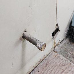 Old gas line sticking out of wall, was previously hidden in a cabinet.