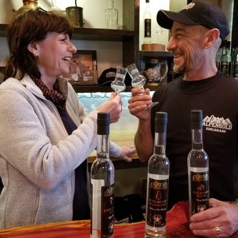 AFT Distillery - a man and a woman holding wine glasses - Distilleries Near Me - Luling, Texas