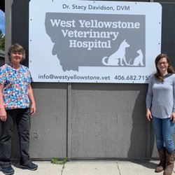 West Yellowstone Veterinary Hospital - Dr. Stacy and Connie in front of the new sign.