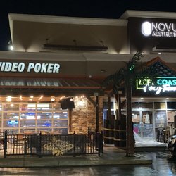 Left Coast Gaming Tavern - Crew member power washing the patios